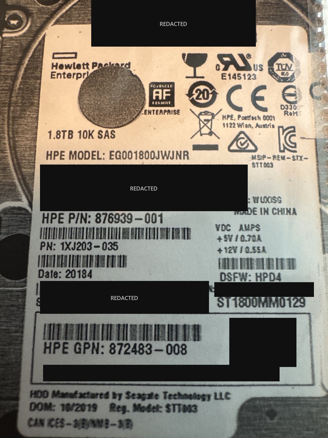 HPE 1.8 TB 10K SAS enterprise drive label, model EG001800JWJNR, with serial numbers, WWN, PSID and data-matrix code redacted