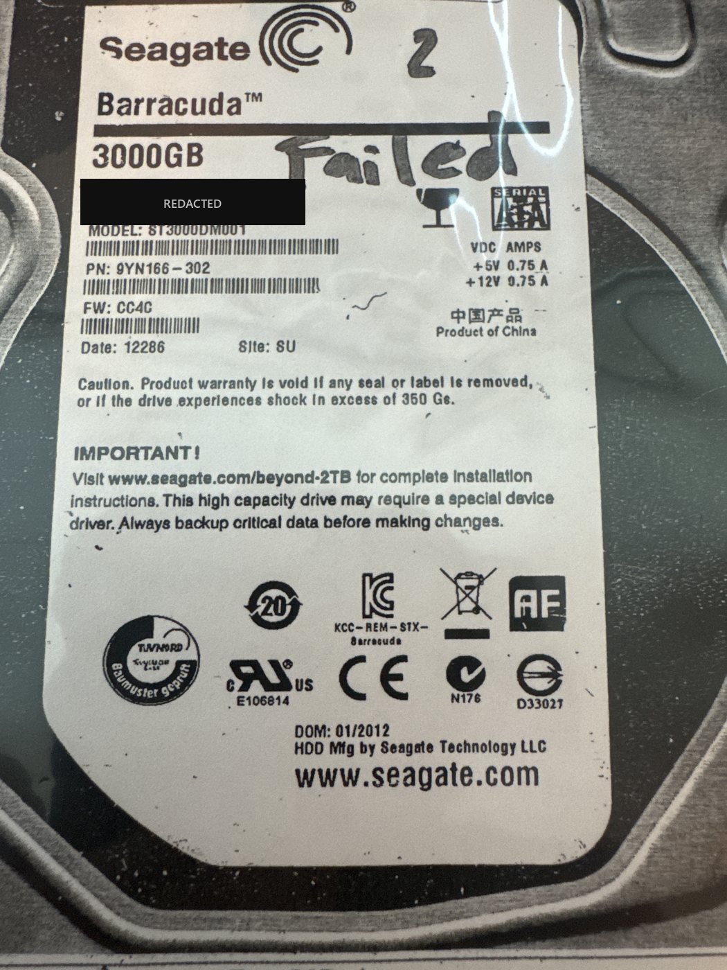 Seagate Barracuda ST3000DM001 3 TB drive labelled by hand as drive 2 and marked "Failed", with the serial number redacted