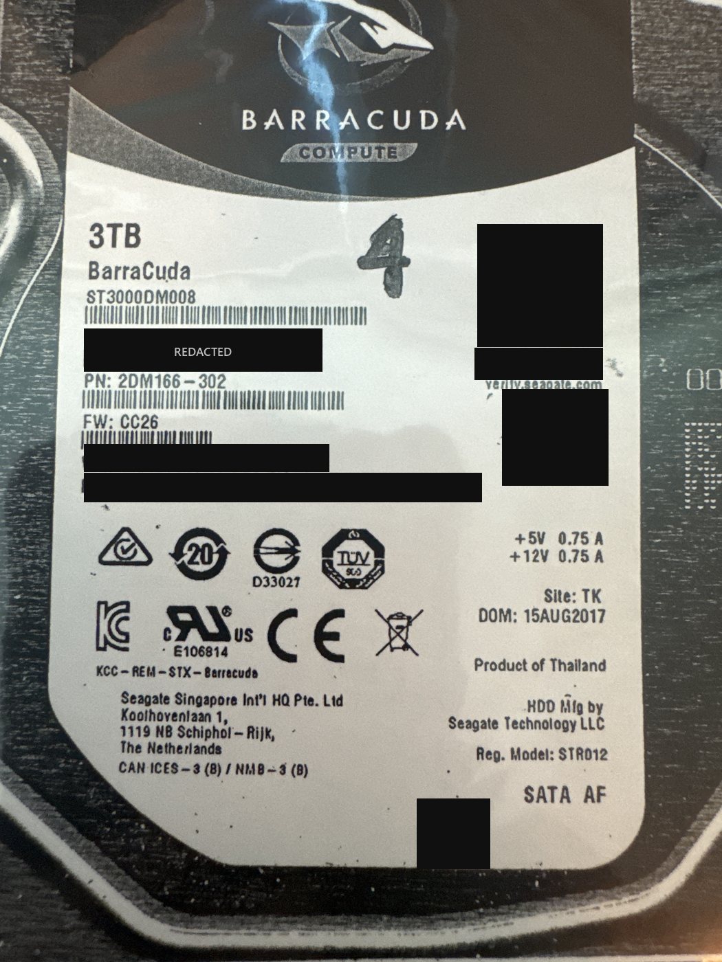 Seagate BarraCuda ST3000DM008 3 TB array member drive label with serial number, WWN, PSID and QR codes redacted