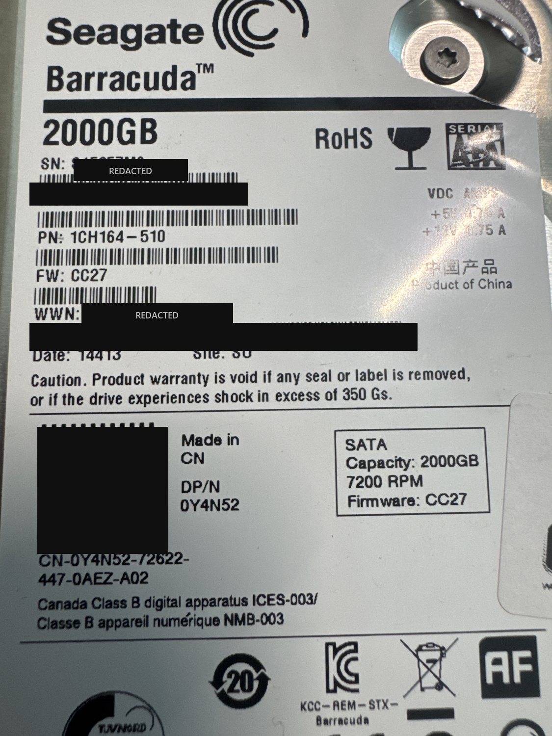 Seagate Barracuda ST2000DM001 2 TB SATA hard drive label with serial number, WWN, barcodes and data-matrix code redacted